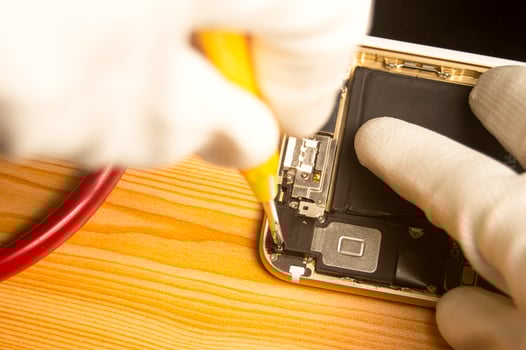 Top view of a technician repairing a smartphone photo