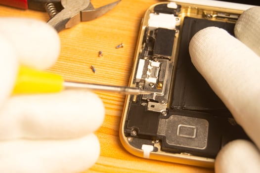 Top view of a technician repairing a smartphone photo