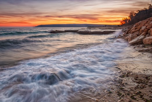 Sea sunset. Beauty sea beach with motion blur water and waves flowing out. photo