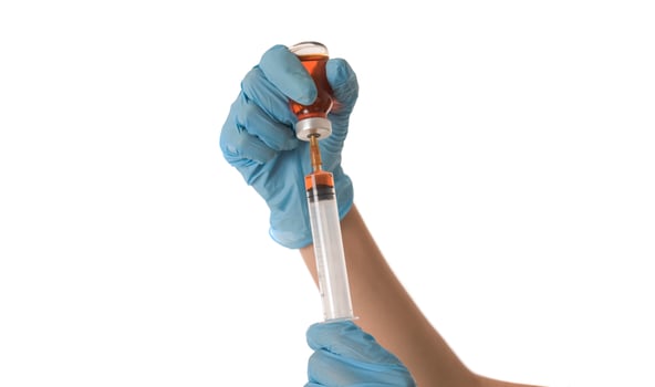 Woman Nurse with protective workwear holding Vaccine and syringe photo