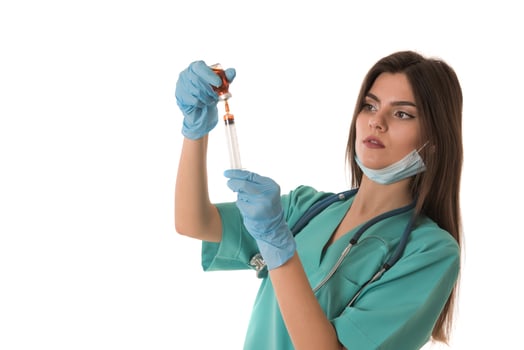 Woman Nurse with protective workwear holding Vaccine and syringe photo
