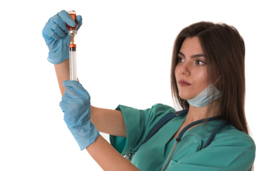 Woman Nurse with protective workwear holding Vaccine and syringe photo