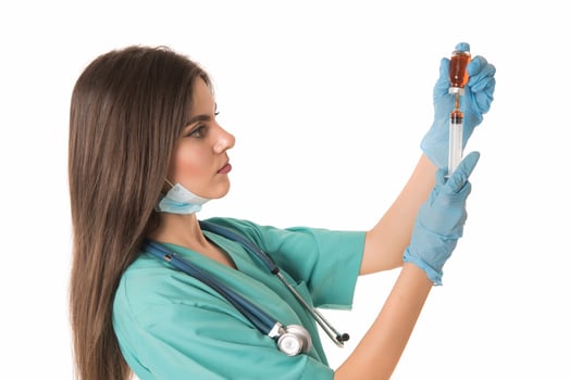 Woman Nurse with protective workwear holding Vaccine and syringe photo