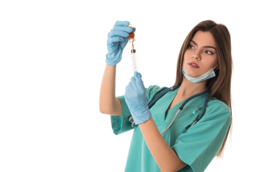 Woman Nurse with protective workwear holding Vaccine and syringe photo