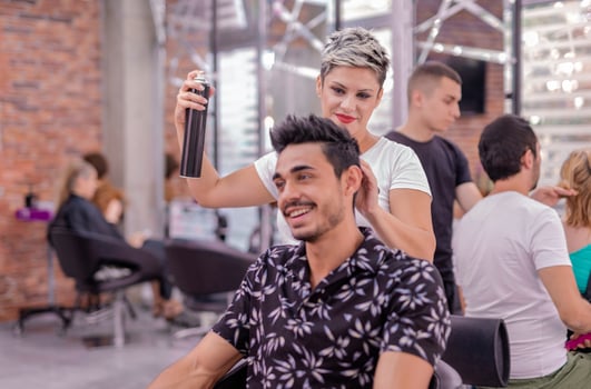 Professional hairdresser is cutting men's hair in beauty salon. photo