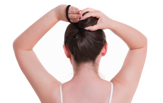 pretty young woman adjusting her hair before taking a shower. photo
