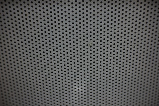 photo of a small hole in the back of an iron chair can be used as wallpaper or background.