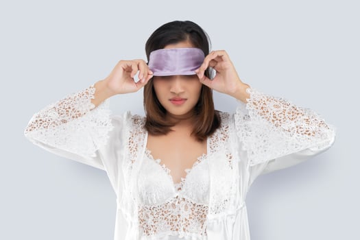 Asian woman take off a sleeping mask photo