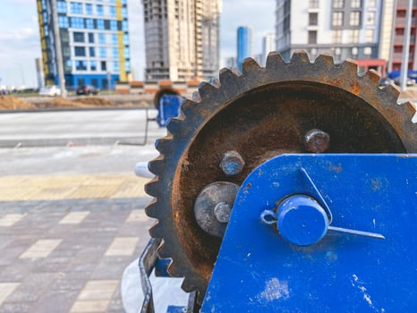 metal, rusty and old reel with a wound electric cable. construction site. on a metal circle orange rust from water photo
