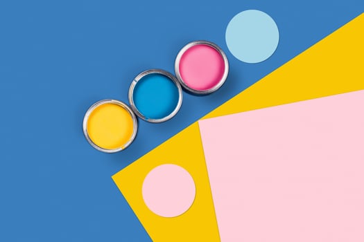 Three-colored background with paint jars. photo