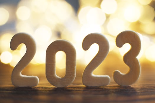 wooden number 2023 onchristmas beautifull shiny gold background. sparkle festive blurred bokeh photo