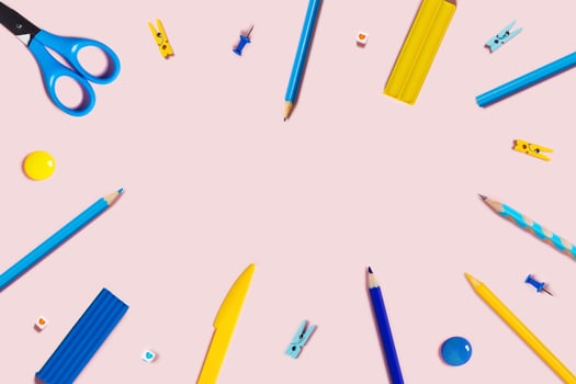 Pink background with writing materials. photo