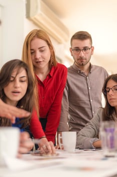 business woman explaining business matters to her team in a boardroom photo