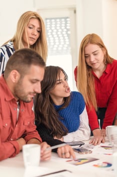 business woman explaining business matters to her team in a boardroom photo