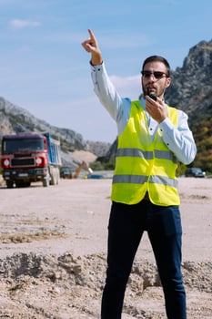 Surveyor engineer is measuring level on construction site. Surveyors ensure precise measurements before undertaking large construction projects. photo
