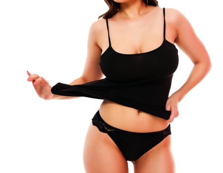 Woman with sexy body posing against a white background photo