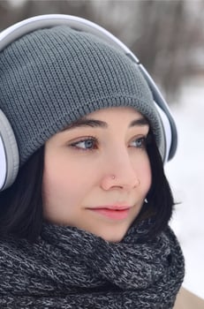 Winter portrait of young girl with headphones photo