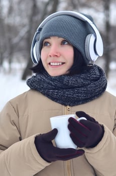 Young girl with headphones and coffee cup photo