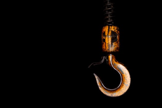 Crane hook. The system of pulleys and ropes. Close up crane hook for overhead crane. Isolated on black background. photo