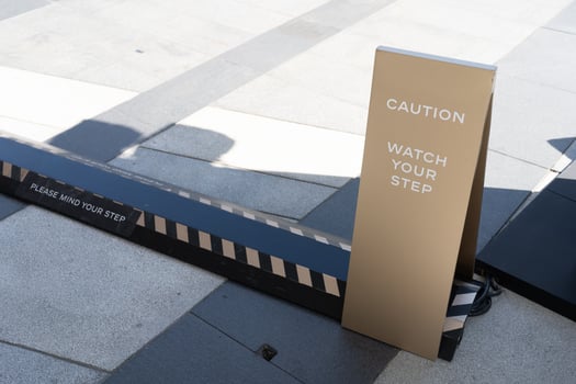watch your step sign on the floor. photo