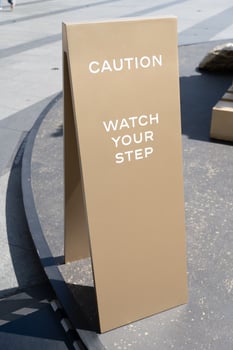 watch your step sign on the floor. photo