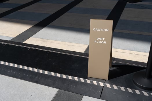 watch your step sign on the floor. photo