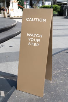 watch your step sign on the floor. photo
