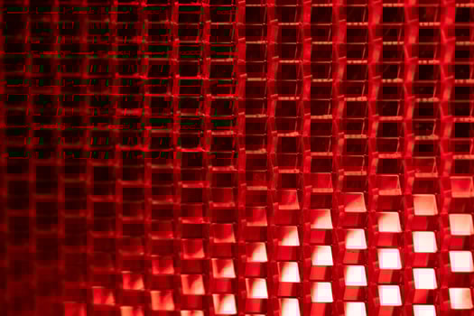 red background - detail of a red traffic warning lamp. The brake light assembly of a modern automobile photo