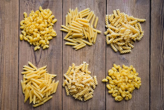 Raw pasta various kinds of uncooked pasta macaroni spaghetti and noodles, Italian food culinary concept, Collection of different raw pasta on cooking table for cooking food photo