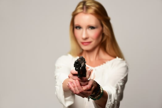 beautiful secret agent holding hand gun, isolated on white photo