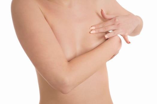 Young topless woman doing breast self-exam BSE. Checking up breast changes, possible lumps, distortions or swelling. Breast cancer awareness. photo