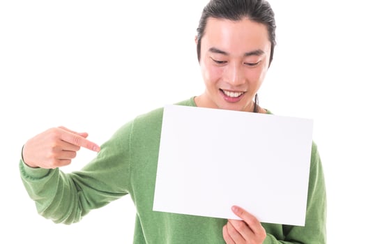 Handsome Asian man holding blank empty banner doing ok sign with fingers, smiling friendly photo