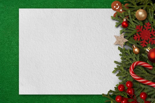christmas ornament sitting on a green table and blank white paper photo