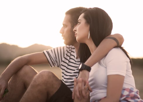 Picnic holiday concept. Beautiful couple having fun making BBQ on bonfire and relaxing by a lake. photo