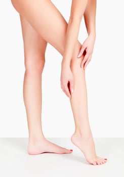 Female legs and hands, white background photo