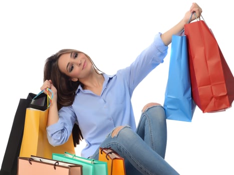 Shopping concept. Beautiful smiling brunette with shopping bags posing on white background photo