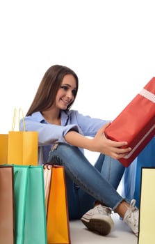 Beautiful smiling brunette with shopping bags. Shopping concept in studio photo