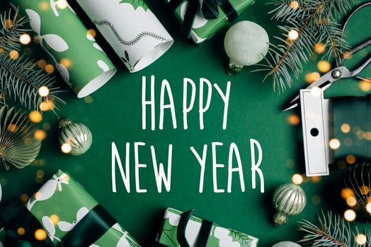 Happy New Year Greeting card. Christmas decoration and wrapp present, fir tree on green background. Winter xmas holiday theme. Happy New Year. Flat lay photo