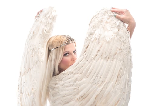 Portrait of beautiful blonde woman with angel's wings. Angel with long curly hair photo