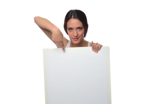 young smiling woman holding a blank sheet of paper for advertising photo