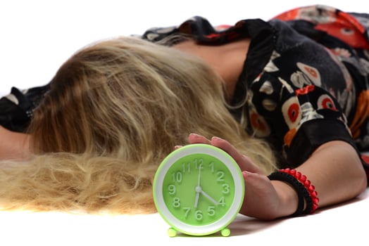 Happy young woman holding clock over isolated white background photo
