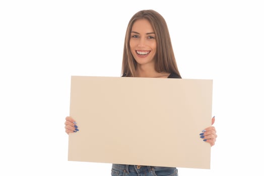 smiling girl holding blank sign board. studio portrait of young woman with sign card. isolated. photo