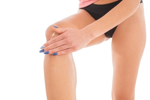 Body care. Unknown Woman applying cream on legs. Female applying anti cellulite cream photo