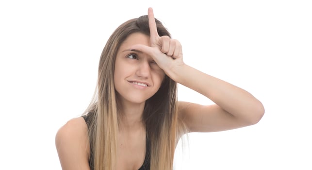 funny female model over white background crosses eyes and makes fish lips funny grimace photo