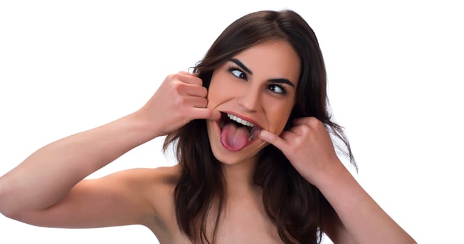 squint eyed woman with weird expression isolated on white photo