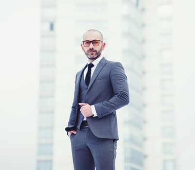 Confident young man in full gray suit photo