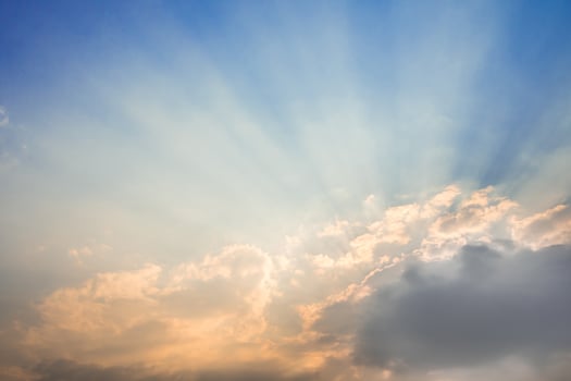 Sunbeam of the sun behind the clouds photo