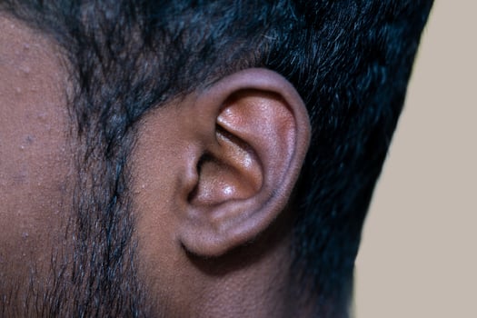 Human Ear - Close up of a man's ear Its body part helps to hear sound waves. photo