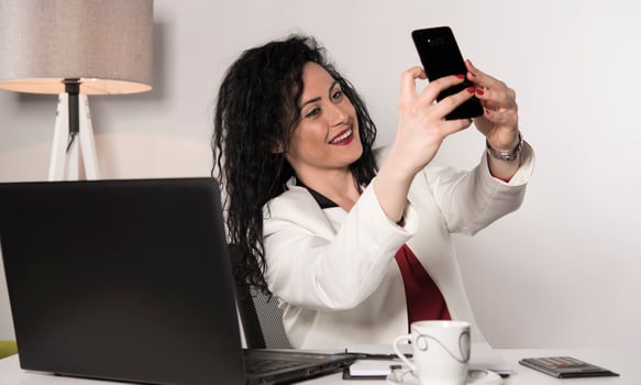 beautiful business woman sitting in her office and talking on the cellphone. business concept photo