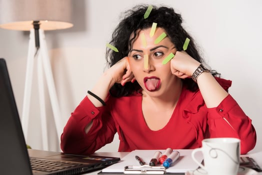 Pretty female model with a lot of post it notes working in her office. photo